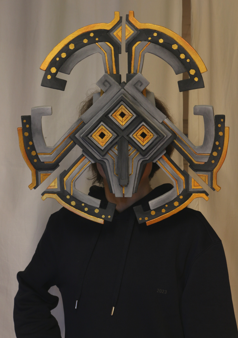 Me, wearing the Nomai Mask on my face in front of a white curtain.